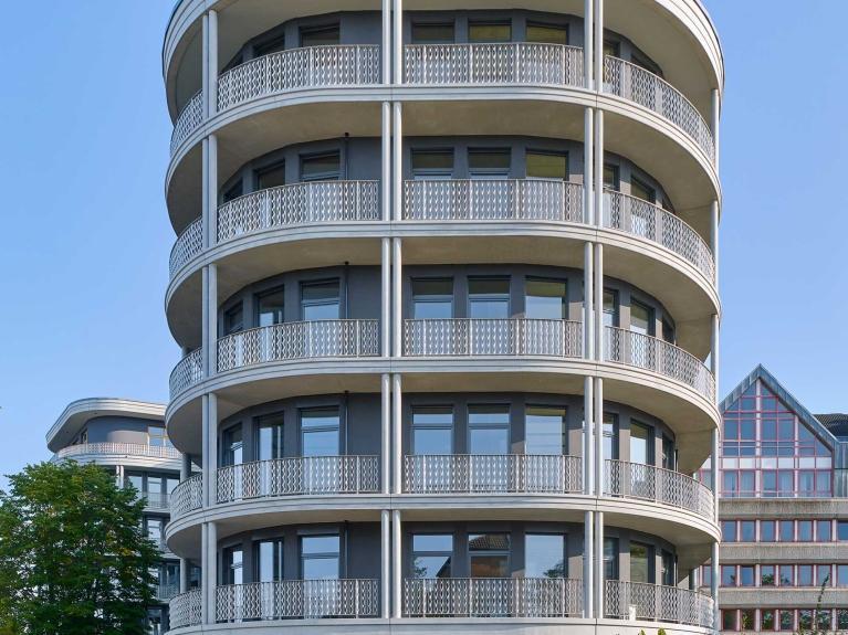 Visualisierung der Außenfassade eines Neubau-Bürogebäudes mit runder Architektur und reduziertem CO₂-Ausstoß