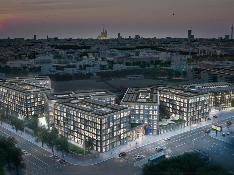 Visualisierung des Neubau-Bürogebäudes Friedrich und Karl in Köln aus der Vogelperspektive bei Dämmerung mit beleuchteten Fenstern